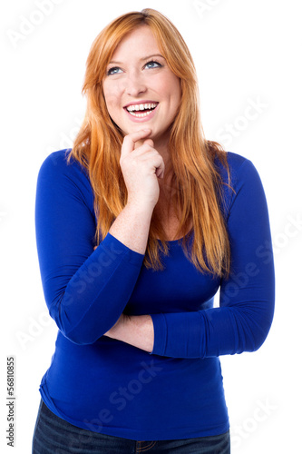 Photo: Young laughing woman imagining something Young laughing woman imagining something