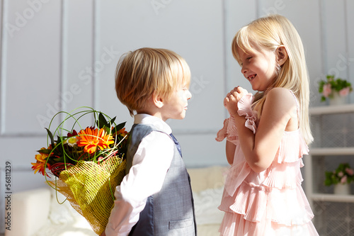 Photo: Boy is presented flowers to girl Boy is presented flowers to girl