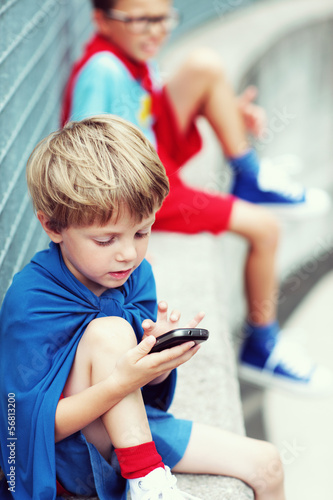 Photo: Little Superhero with smartphone Little Superhero with smartphone