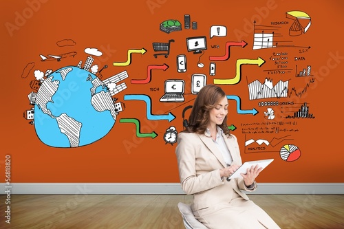 Photo: Pleased businesswoman using a tablet pc sitting on chair Pleased businesswoman using a tablet pc sitting on chair