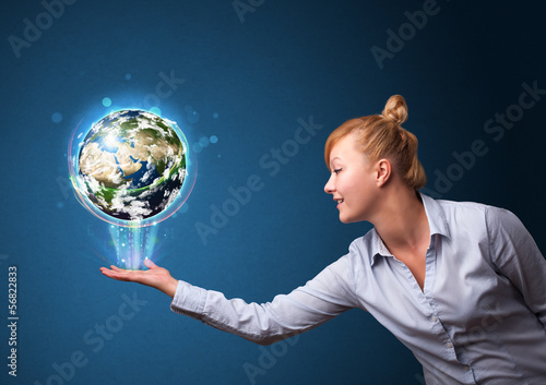 Photo: Businesswoman holding glowing earth globe Businesswoman holding glowing earth globe