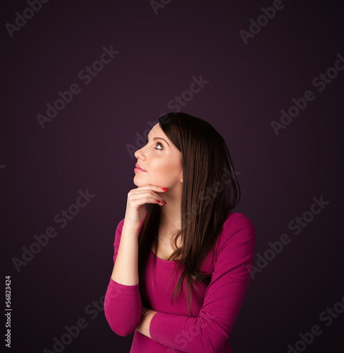 Photo: Young woman thinking with copy space Young woman thinking with copy space