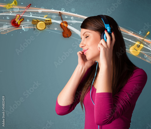 Photo: Young woman with headphones listening to music Young woman with headphones listening to music