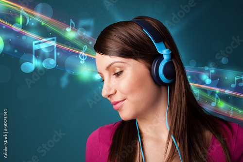 Photo: Young woman listening to music with headphones Young woman listening to music with headphones