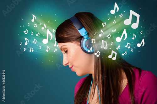 Photo: Young woman with headphones listening to music Young woman with headphones listening to music