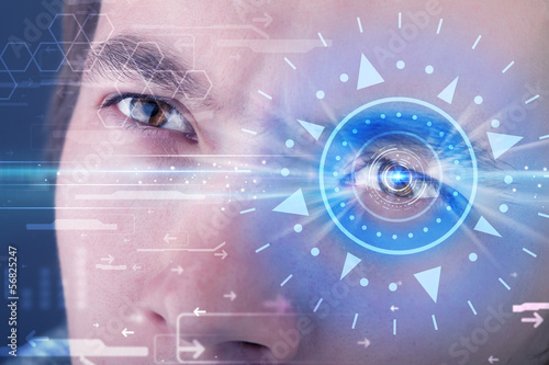 Photo: Cyber man with technolgy eye looking into blue iris Cyber man with technolgy eye looking into blue iris