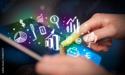 Photo: Hand touching tablet pc, charts concept Hand touching tablet pc, charts concept