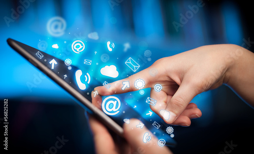 Photo: Hand touching tablet pc, social media concept Hand touching tablet pc, social media concept