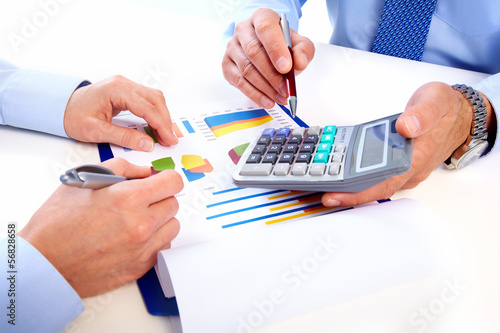Photo: Hands of business people with calculator. Hands of business people with calculator.