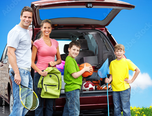 Photo: Happy family near new car. Happy family near new car.