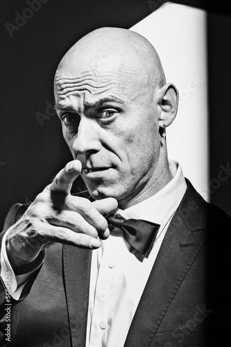 Photo: Male portrait look at the camera with pointing finger B&W image Male portrait look at the camera with pointing finger B&W image