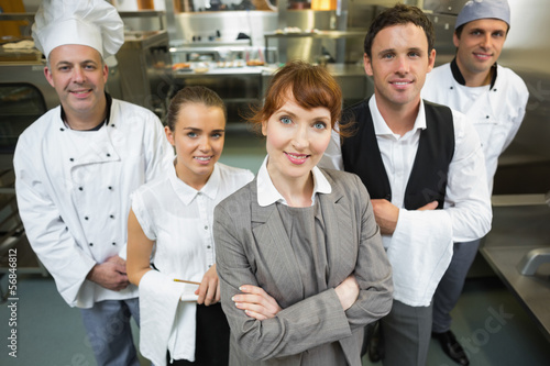 Photo: Cute female manager posing with the staff Cute female manager posing with the staff
