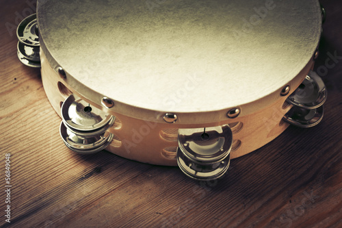 Photo: Wooden tambourine on a table Wooden tambourine on a table