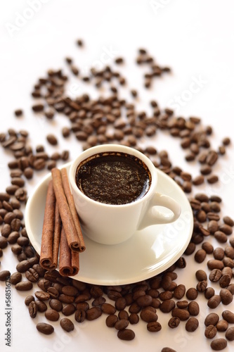 Photo: Cup of coffee, cinnamon on a background of beans Cup of coffee, cinnamon on a background of beans
