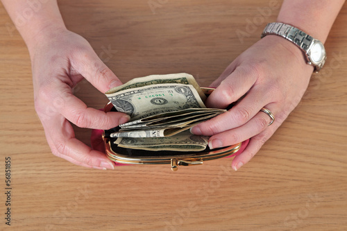 Photo: Woman taking money out of her purse Woman taking money out of her purse