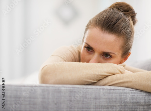 Photo: Stressed young woman sitting on sofa Stressed young woman sitting on sofa
