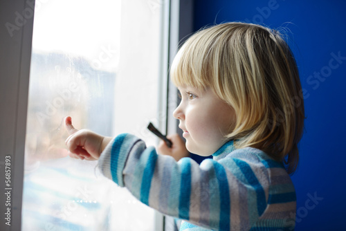 Photo: girl looking through the window girl looking through the window