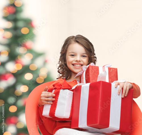 Photo: happy child girl with gift boxes happy child girl with gift boxes