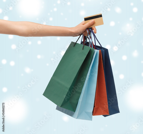 Photo: woman with shopping bags and credit card woman with shopping bags and credit card