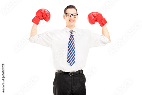 Photo: Excited man with tie and red boxing gloves, celebrating a win Excited man with tie and red boxing gloves, celebrating a win