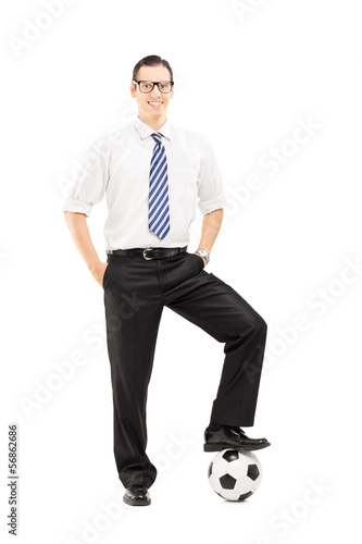 Photo: Full length portrait of a smiling man with a soccer ball Full length portrait of a smiling man with a soccer ball