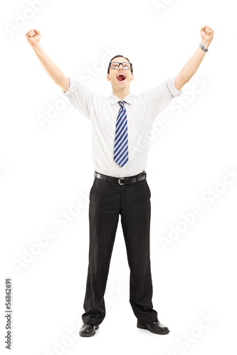 Photo: Excited male with raised hands gesturing happiness Excited male with raised hands gesturing happiness