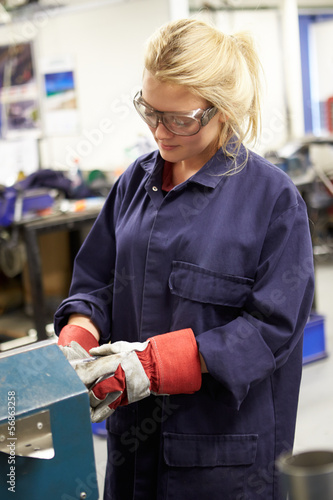 Photo: Apprentice Engineer Working On Factory Floor Apprentice Engineer Working On Factory Floor