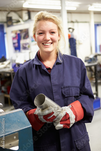 Photo: Apprentice Engineer Working On Factory Floor Apprentice Engineer Working On Factory Floor