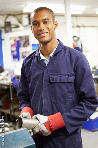 Photo: Apprentice Engineer Working On Factory Floor Apprentice Engineer Working On Factory Floor
