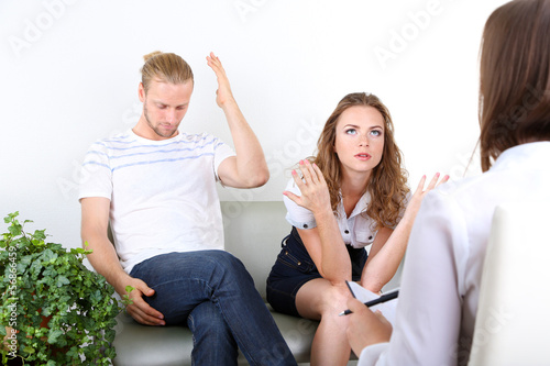 Photo: Young couple with problem on reception for family psychologist Young couple with problem on reception for family psychologist