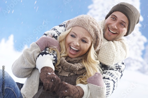 Photo: Happy loving couple sledging Happy loving couple sledging