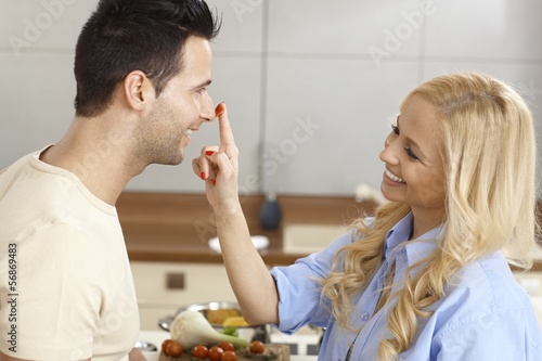 Photo: Loving couple having fun in kitchen Loving couple having fun in kitchen