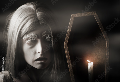 Photo: Creepy vampire woman with light in ghost forest Creepy vampire woman with light in ghost forest