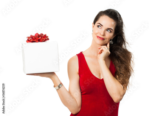 Photo: Woman holding gift and thinking Woman holding gift and thinking