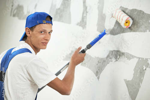 Photo: painter at home renovation work with prime painter at home renovation work with prime