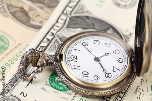 Photo: Pocket watch with financial assets. Pocket watch with financial assets.
