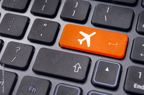 Photo: online booking of flight ticket, with plane sign on keyboard online booking of flight ticket, with plane sign on keyboard