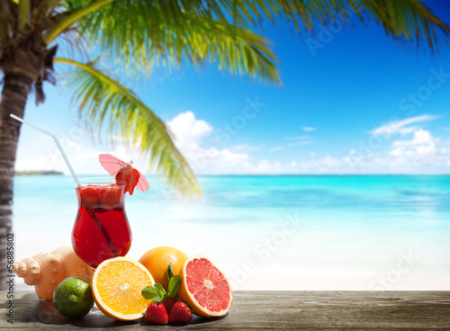 Photo: strawberry cocktail and tropical fruit on the beach strawberry cocktail and tropical fruit on the beach