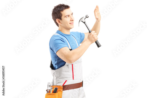 Photo: Male manual worker working with hammer Male manual worker working with hammer