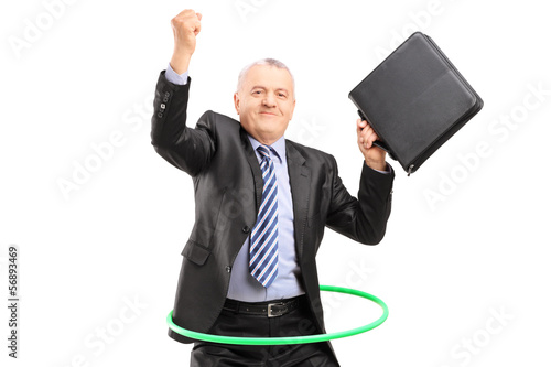 Photo: Matue businessman dancing with a hula hoop Matue businessman dancing with a hula hoop