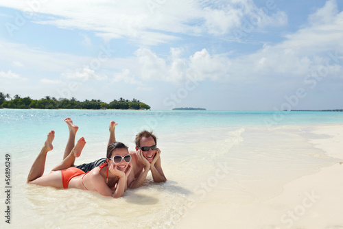 Photo: happy young couple have fun on beach happy young couple have fun on beach