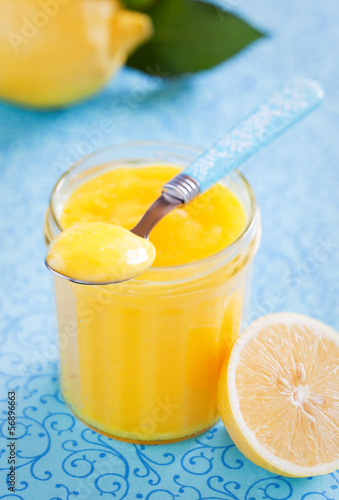 Photo: Homemade lemon curd in glass jar, selective focus Homemade lemon curd in glass jar, selective focus