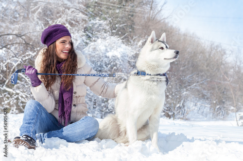 Photo: Young woman with her dog in snow Young woman with her dog in snow