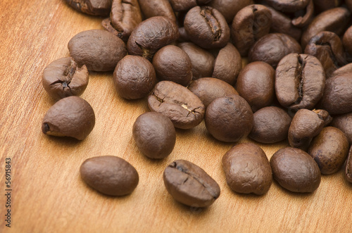Photo: Coffee beans close up on the wood table Coffee beans close up on the wood table