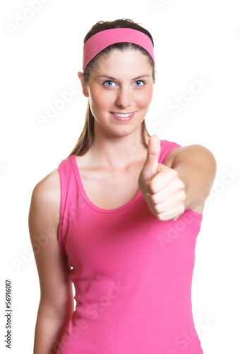 Photo: Laughing sporty woman showing thumb Laughing sporty woman showing thumb