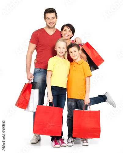 Photo: family with shopping bags standing at studio family with shopping bags standing at studio