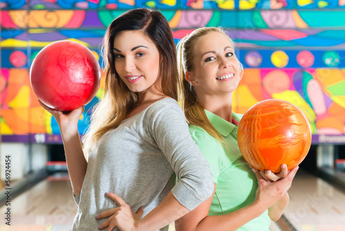 Photo: Young women playing bowling and having fun Young women playing bowling and having fun