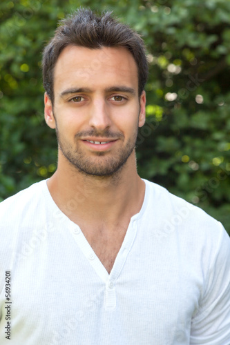 Photo: Smiling latin man in a park Smiling latin man in a park