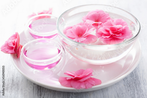 Photo: spa set with begonia flowers and essential oil spa set with begonia flowers and essential oil