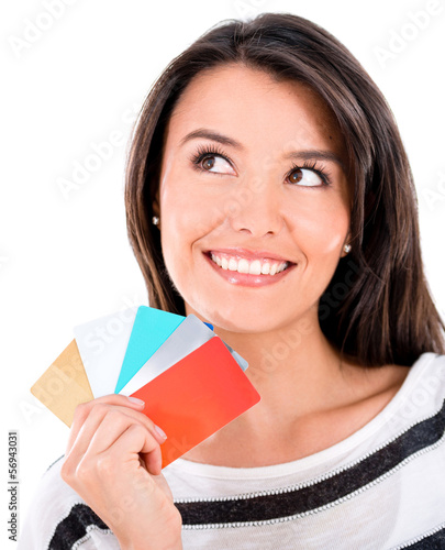 Photo: Pensive woman with credit cards Pensive woman with credit cards